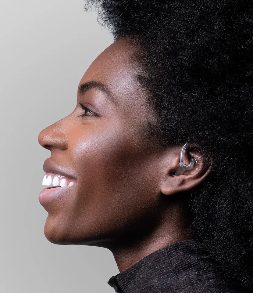 Model wears a claw-shaped titanium earmold in her ear.
